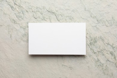 Empty business card light stone textured background, top view. Mockup for design