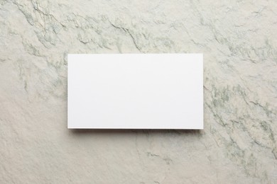 Photo of Empty business card light stone textured background, top view. Mockup for design