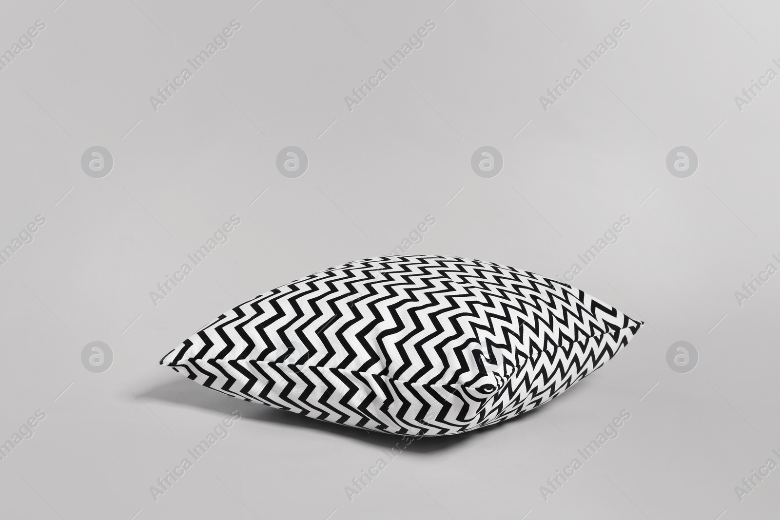 Photo of Single stylish decorative pillow on light background