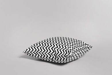 Photo of Single stylish decorative pillow on light background