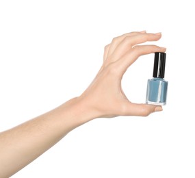 Woman holding nail polish on white background, closeup