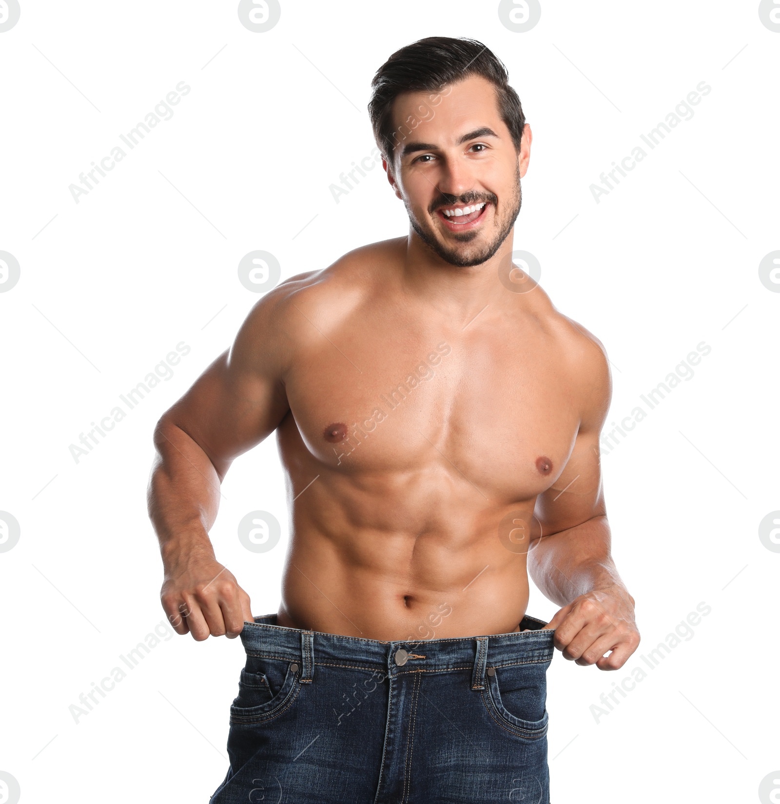 Photo of Young man with slim body in old big size jeans on white background