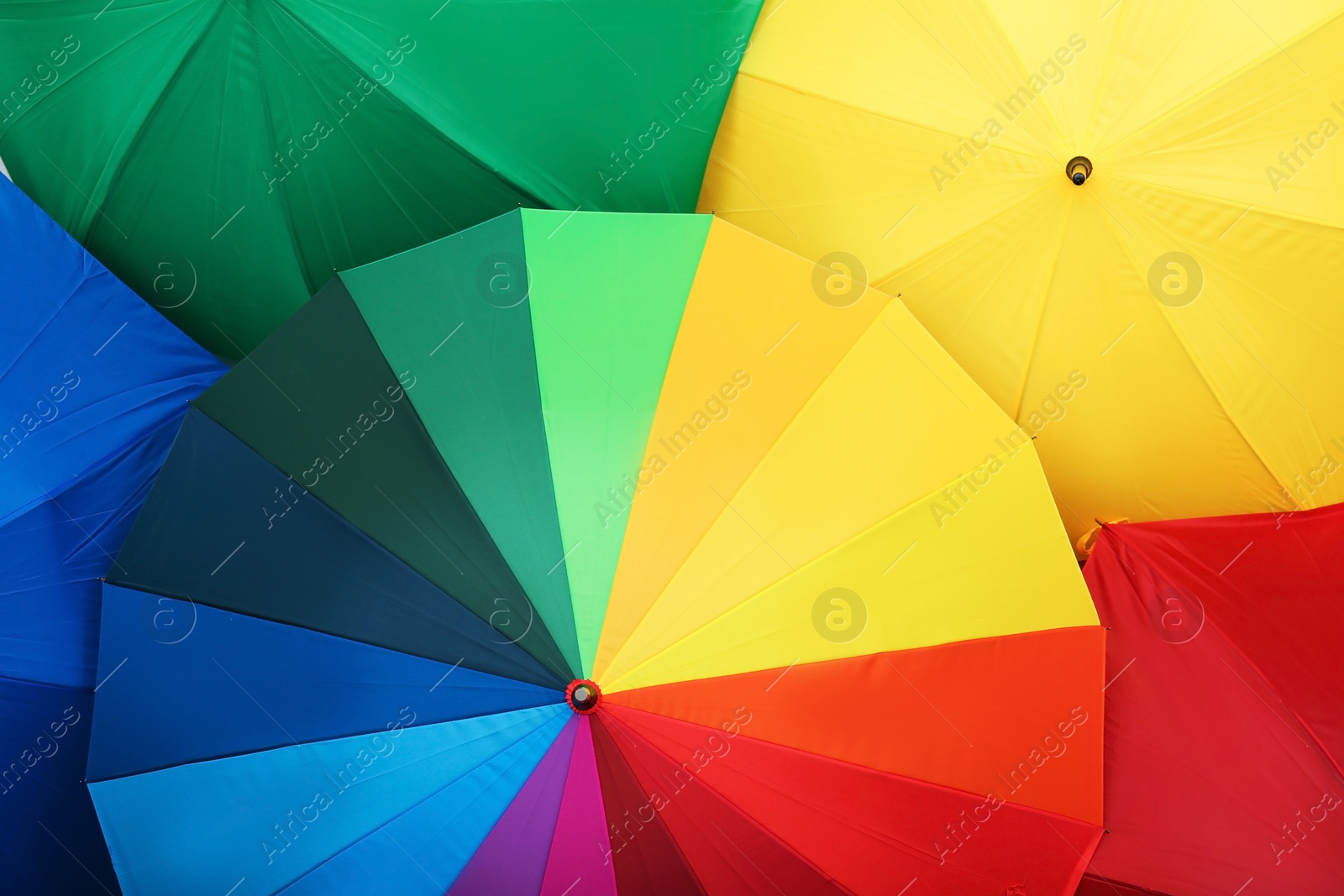 Photo of Many stylish colorful umbrellas as background, closeup