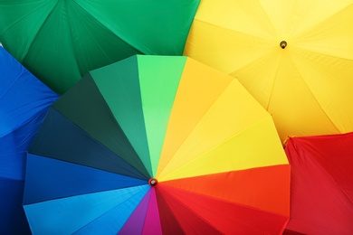 Many stylish colorful umbrellas as background, closeup