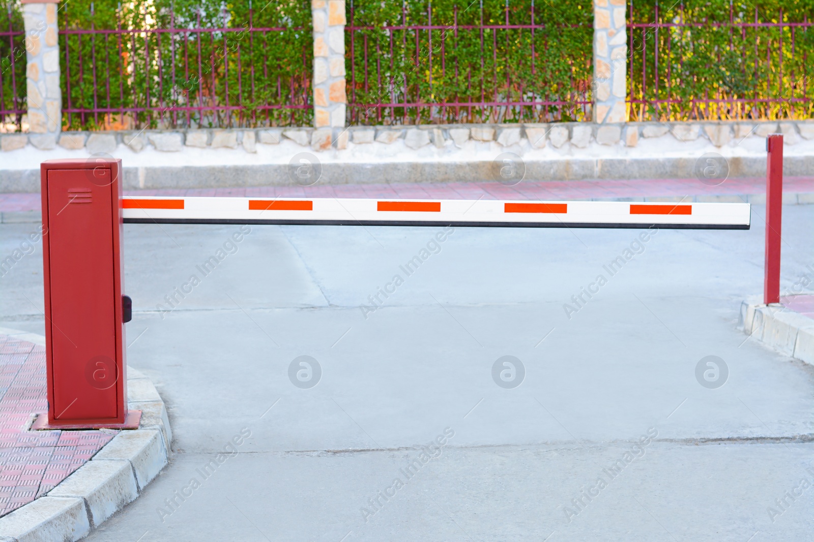 Photo of Closed boom barrier near road on autumn day outdoors