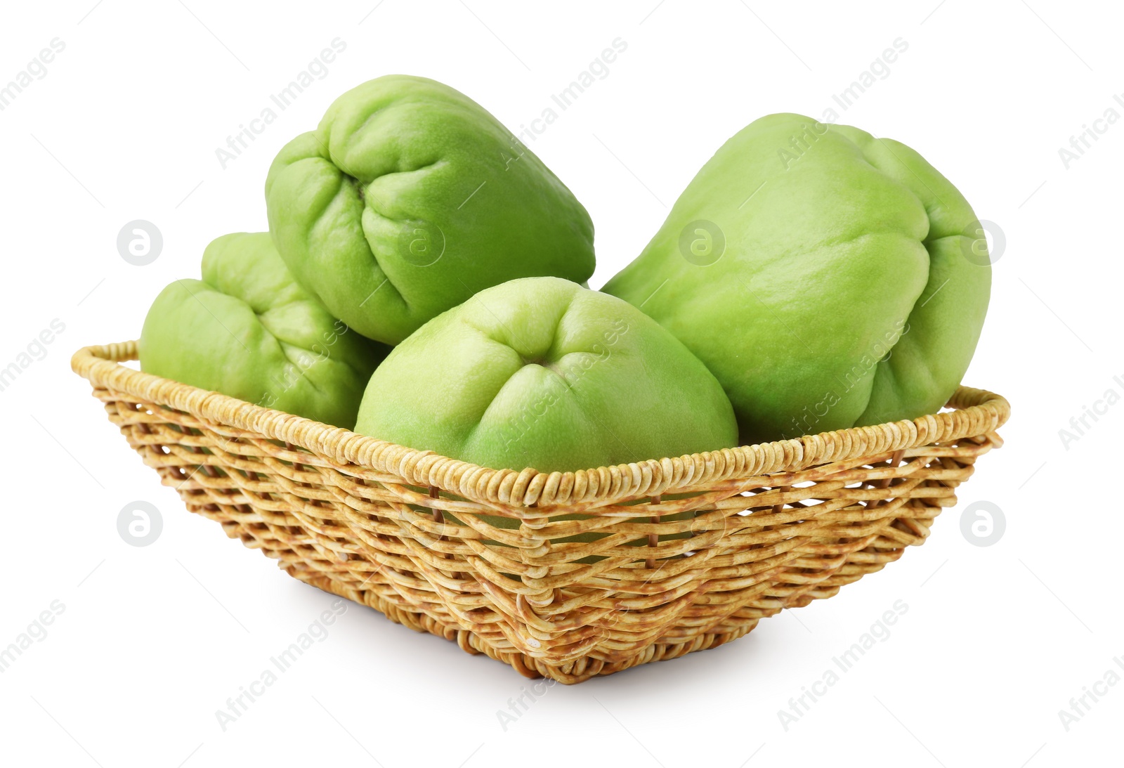 Photo of Fresh green chayote in wicker basket isolated on white