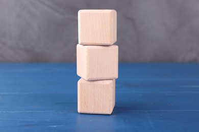 Photo of International Organization for Standardization. Cubes with abbreviation ISO on blue wooden table