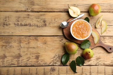 Delicious pear jam and fresh fruits on wooden table, flat lay. Space for text