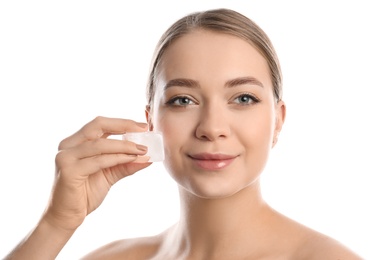 Photo of Young woman with ice cube on white background. Skin care