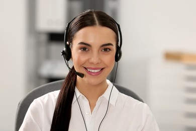 Photo of Hotline operator with headset working in office