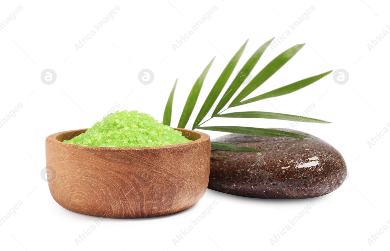 Photo of Green sea salt in bowl, palm leaf and spa stone isolated on white