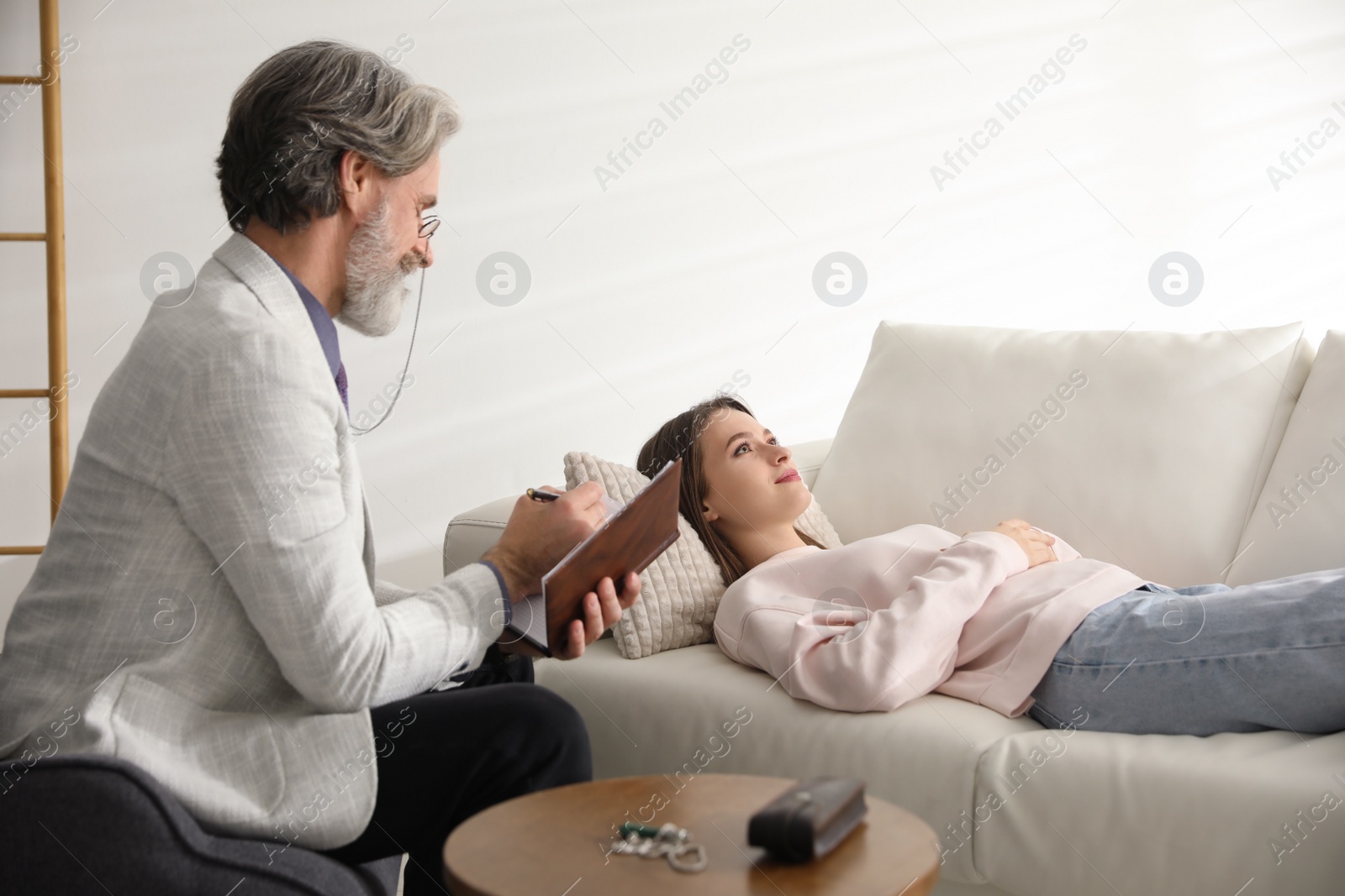 Photo of Psychotherapist and patient in office. Hypnotherapy session