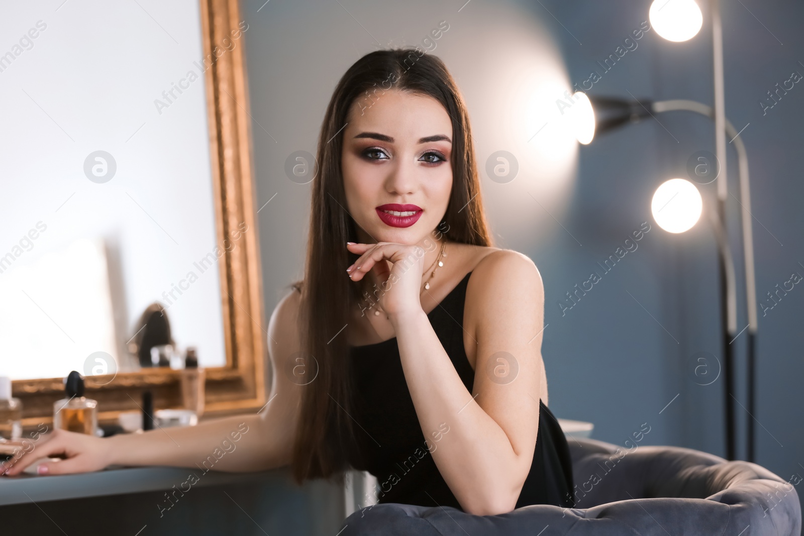 Photo of Portrait of beautiful woman with bright makeup indoors