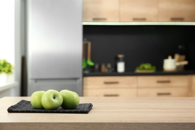 Fresh apples on table in kitchen, selective focus