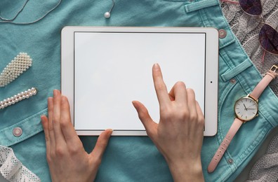 Photo of Woman with modern tablet at table, top view. Space for text