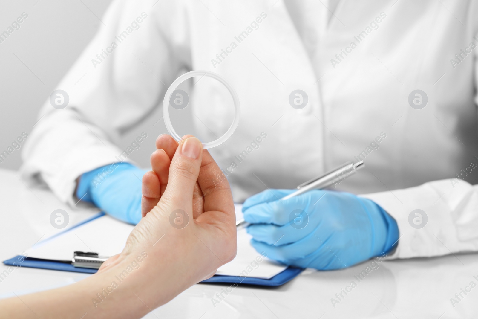 Photo of Woman holding diaphragm vaginal contraceptive ring at the doctor's appointment, closeup