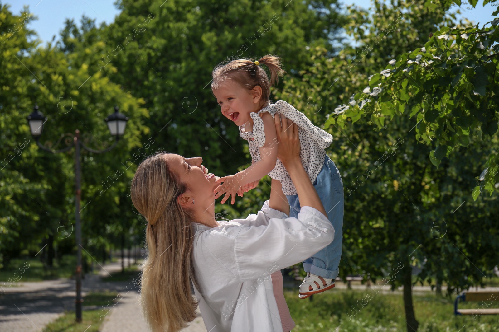 Photo of Happy mother with her daughter spending time together in park