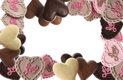 Frame made of heart shaped chocolate candies on white background