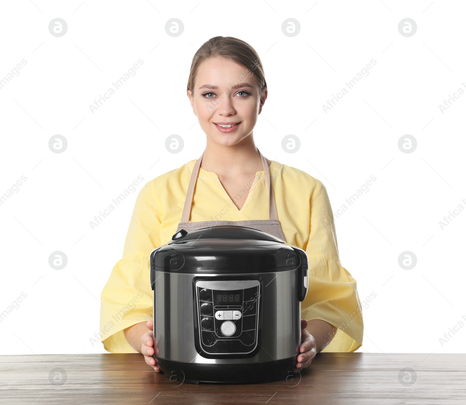 Photo of Portrait of young woman with modern multi cooker at table against white background