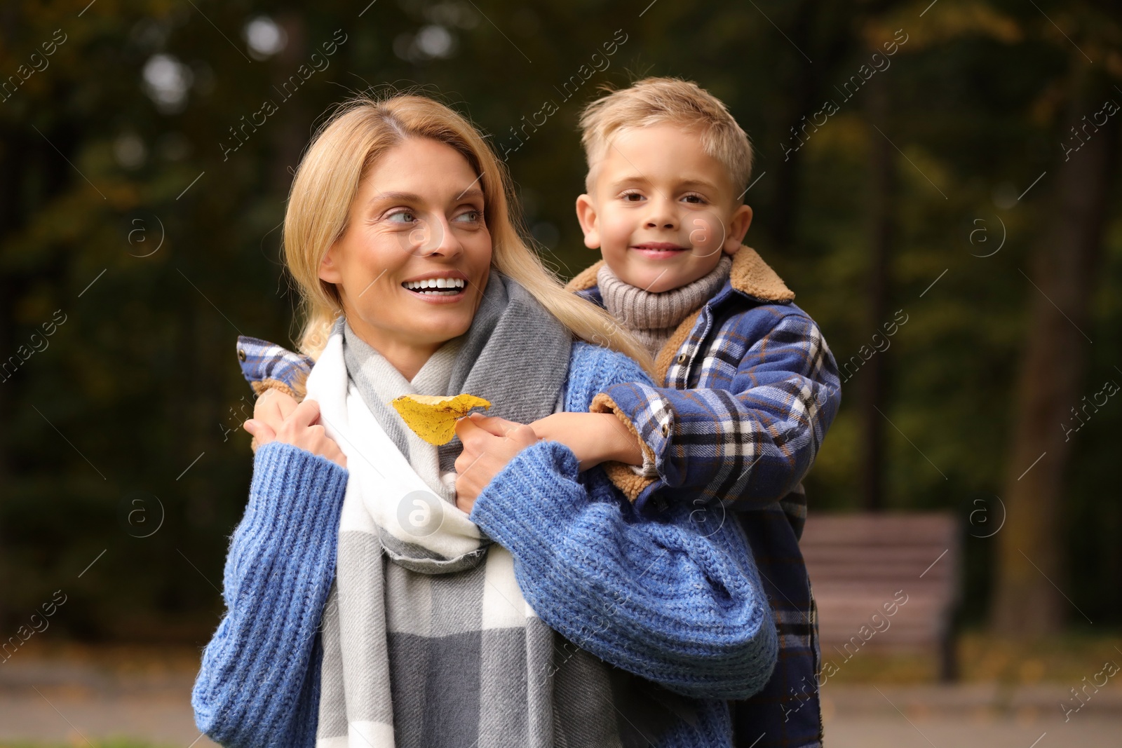 Photo of Happy mother with her son in autumn park