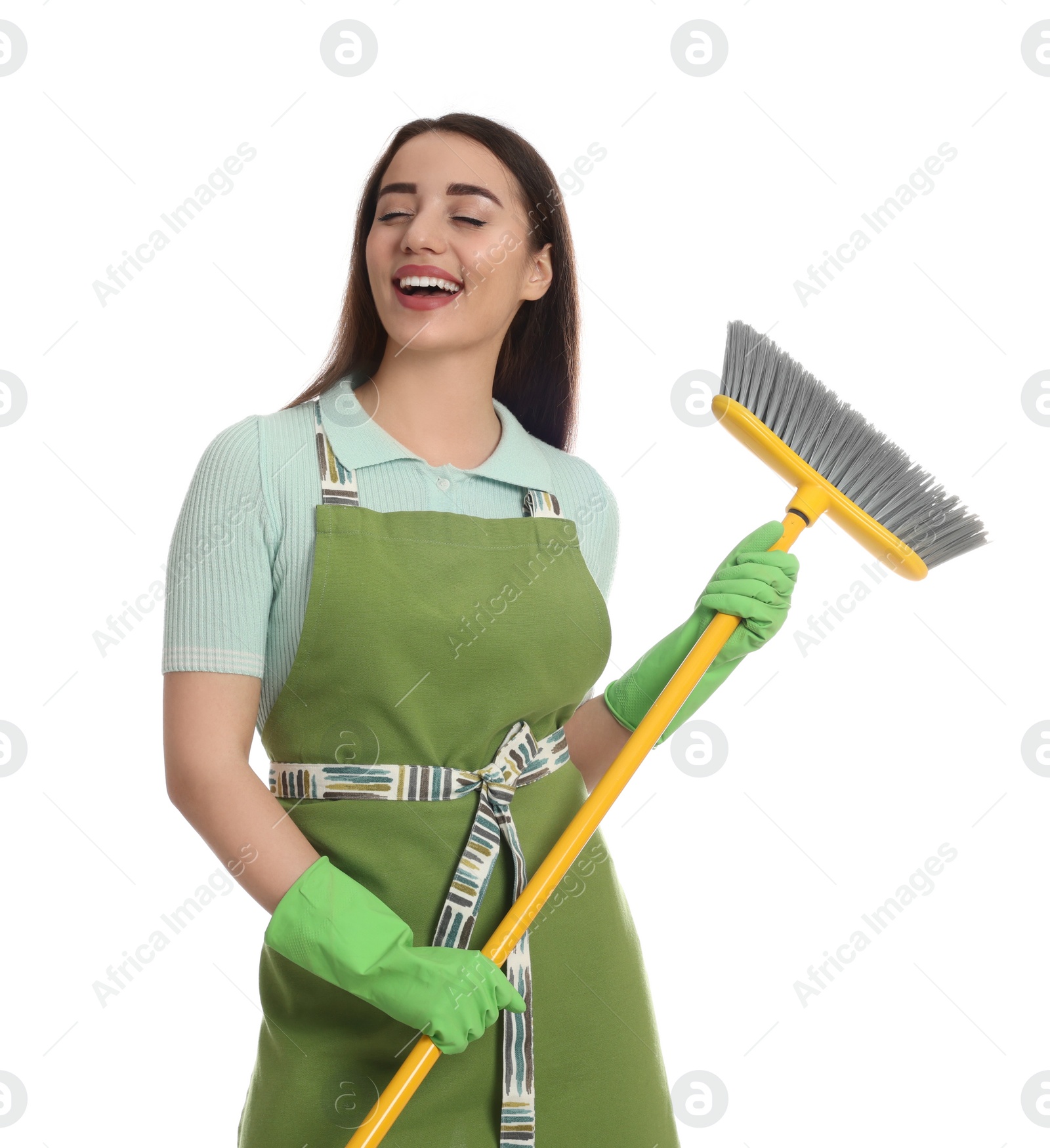 Photo of Beautiful young woman with broom singing on white background