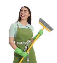 Beautiful young woman with broom singing on white background