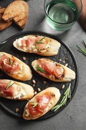 Photo of Flat lay composition with tasty bruschettas on grey table