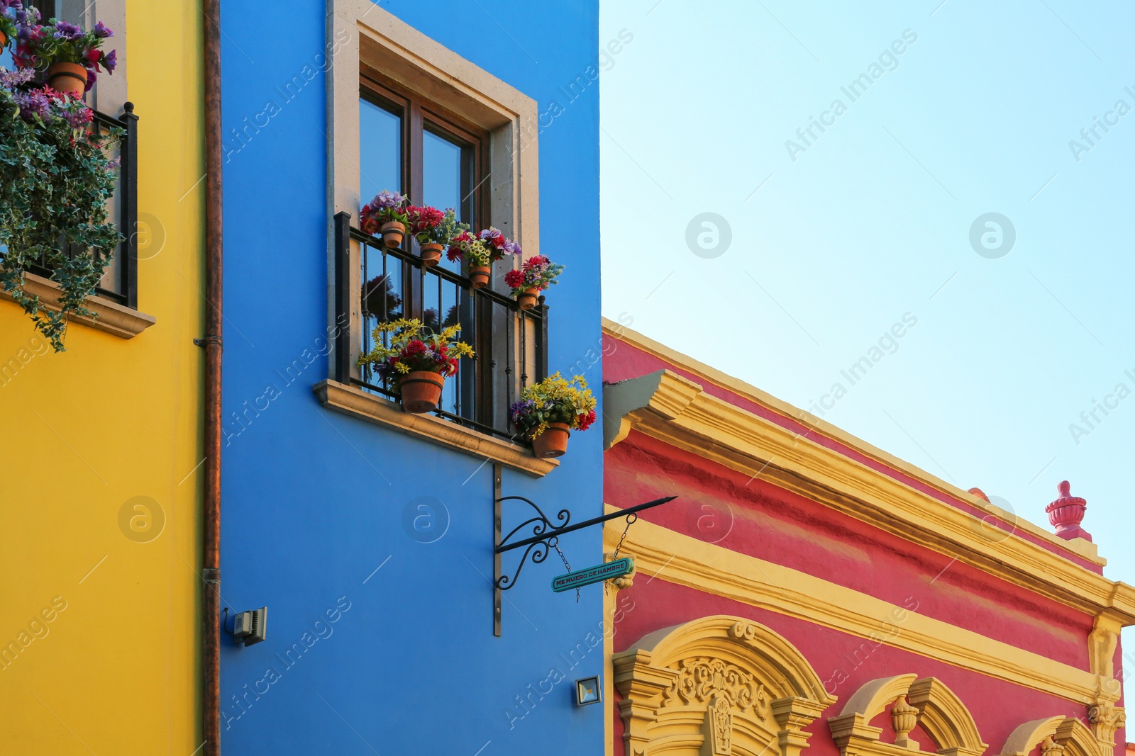 Photo of Building with beautiful window, balcony and potted flowers