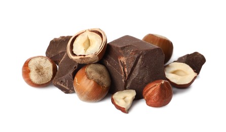 Delicious chocolate chunks and hazelnuts on white background