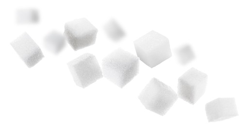 Refined sugar cubes in air on white background