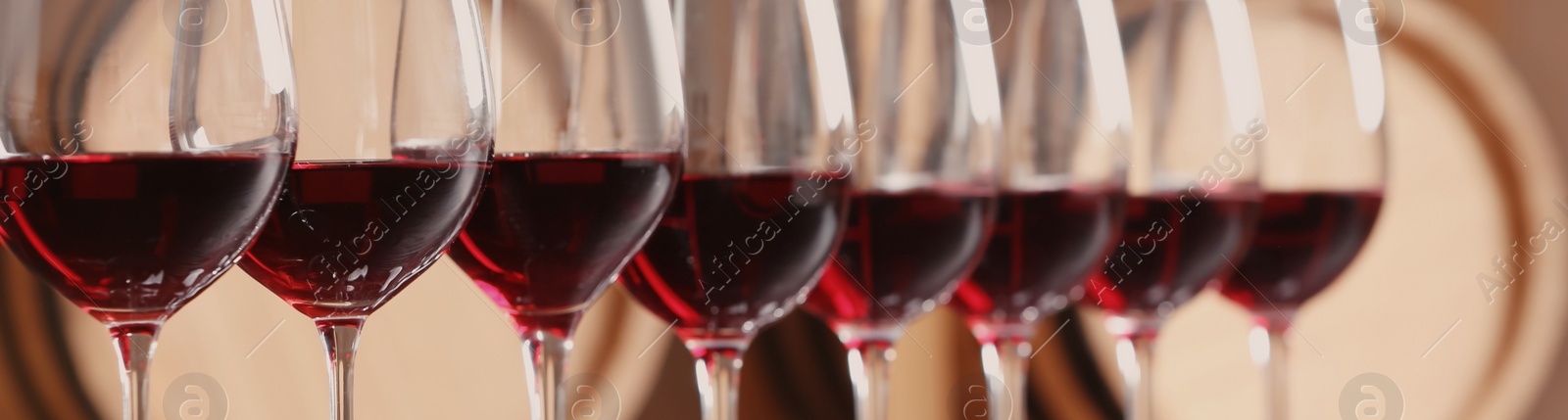 Image of Glasses with tasty red wine, closeup view. Banner design