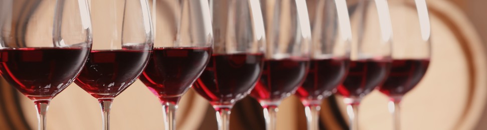 Image of Glasses with tasty red wine, closeup view. Banner design