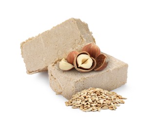 Image of Tasty halva, peeled sunflower seeds and hazelnuts isolated on white