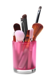 Holder with makeup brushes of professional artist on white background