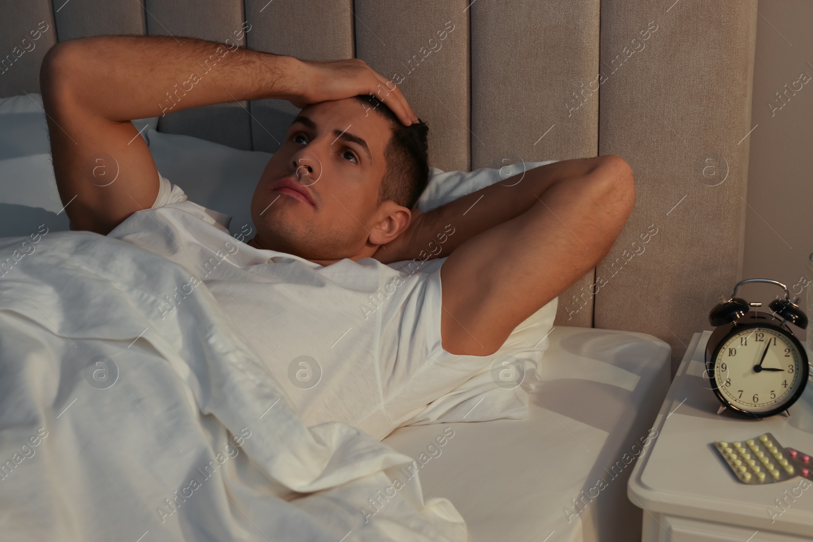 Photo of Man suffering from insomnia in bed at home