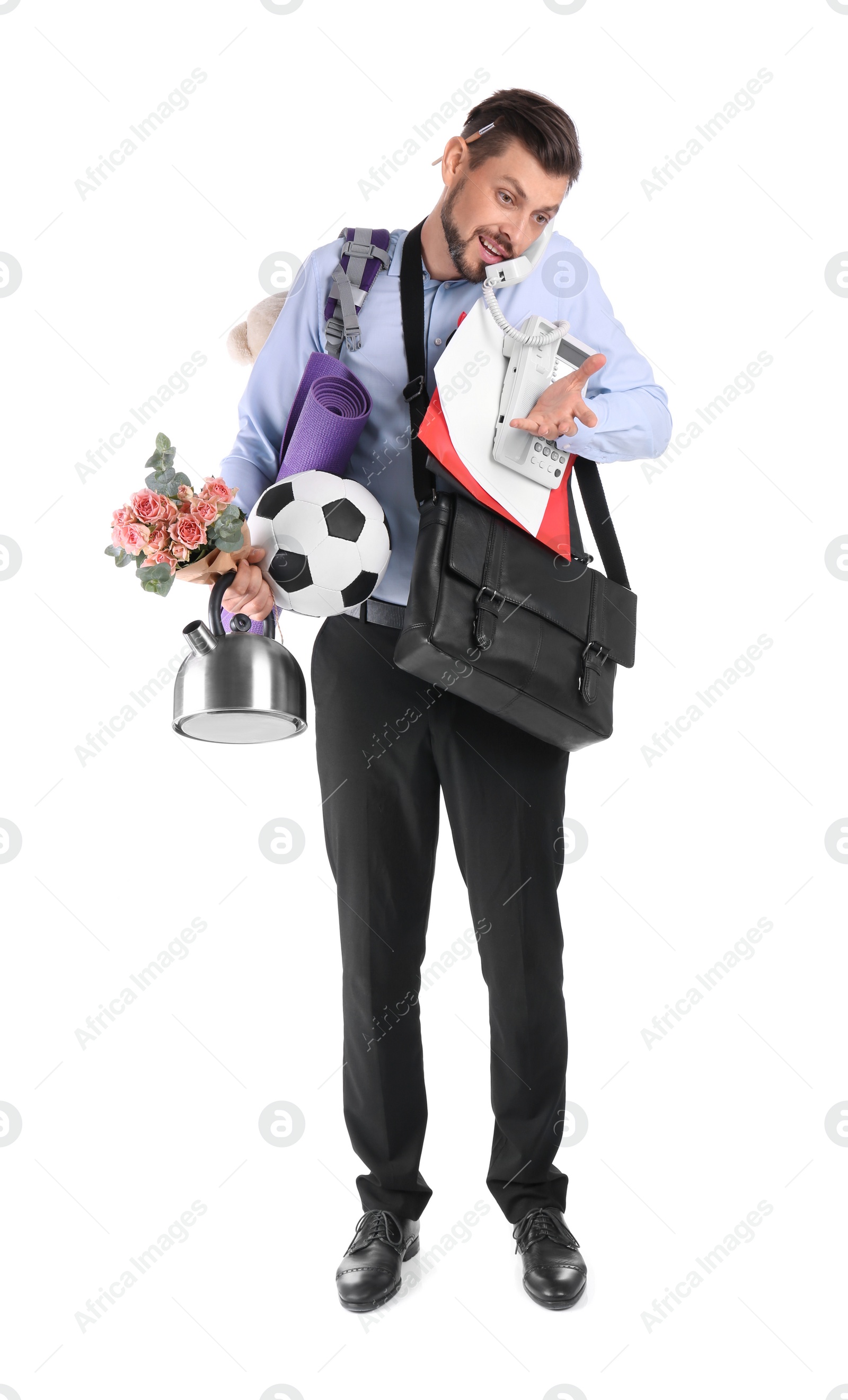 Photo of Businessman with lots of things talking on phone against white background. Combining life and work