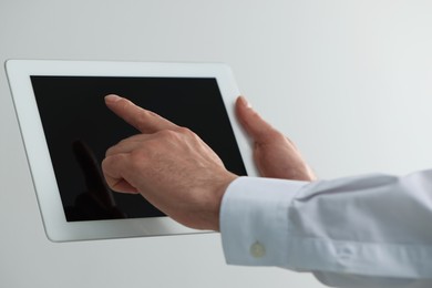 Closeup view of man using new tablet indoors