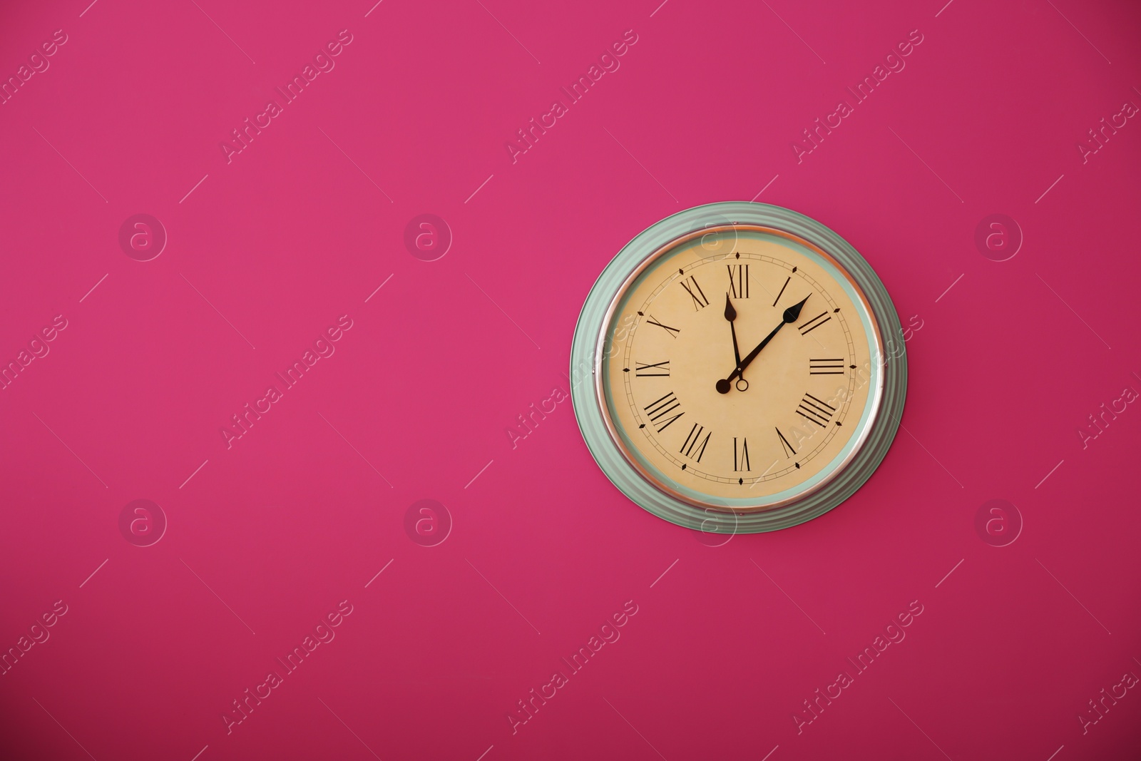 Photo of Stylish clock on color wall. Time concept