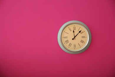 Stylish clock on color wall. Time concept