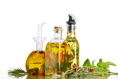 Cooking oil with different spices and herbs in bottles on light table
