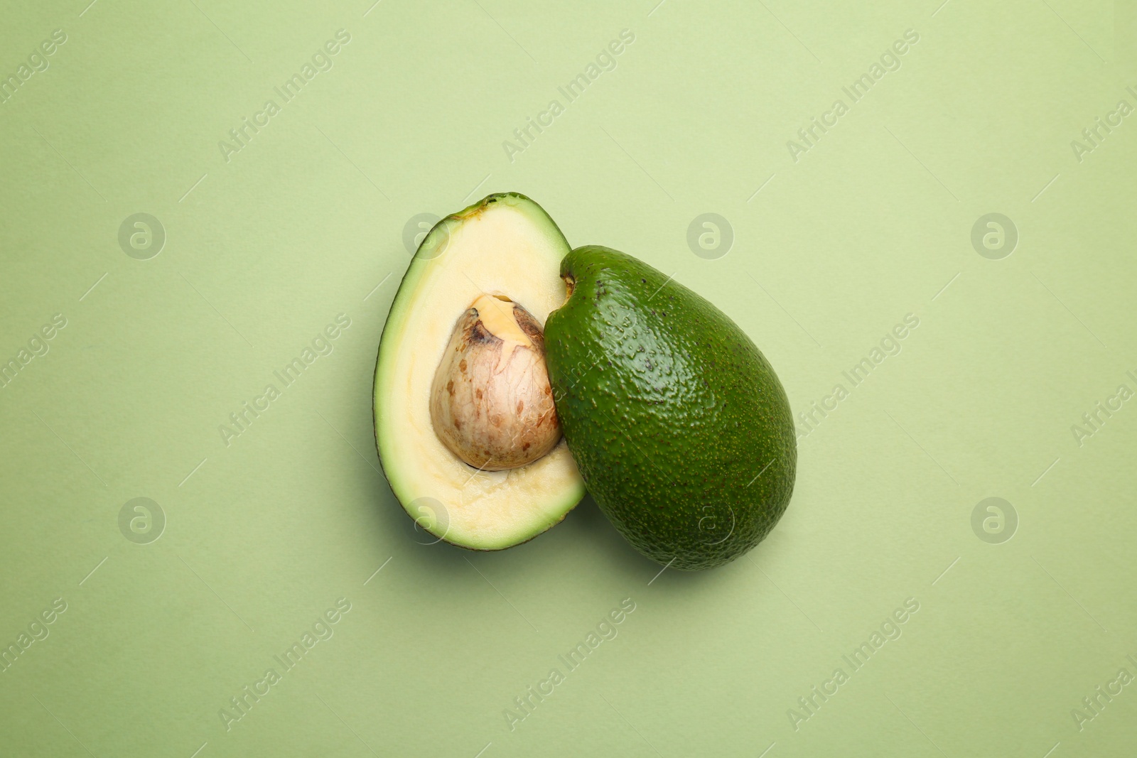 Photo of Cut avocado on color background, top view