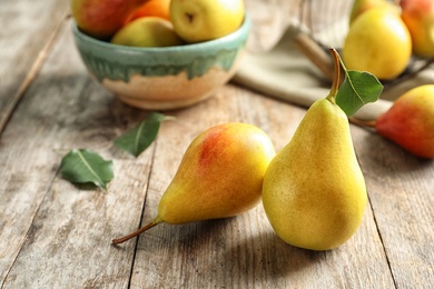 Photo of Ripe pears on wooden table. Healthy snack