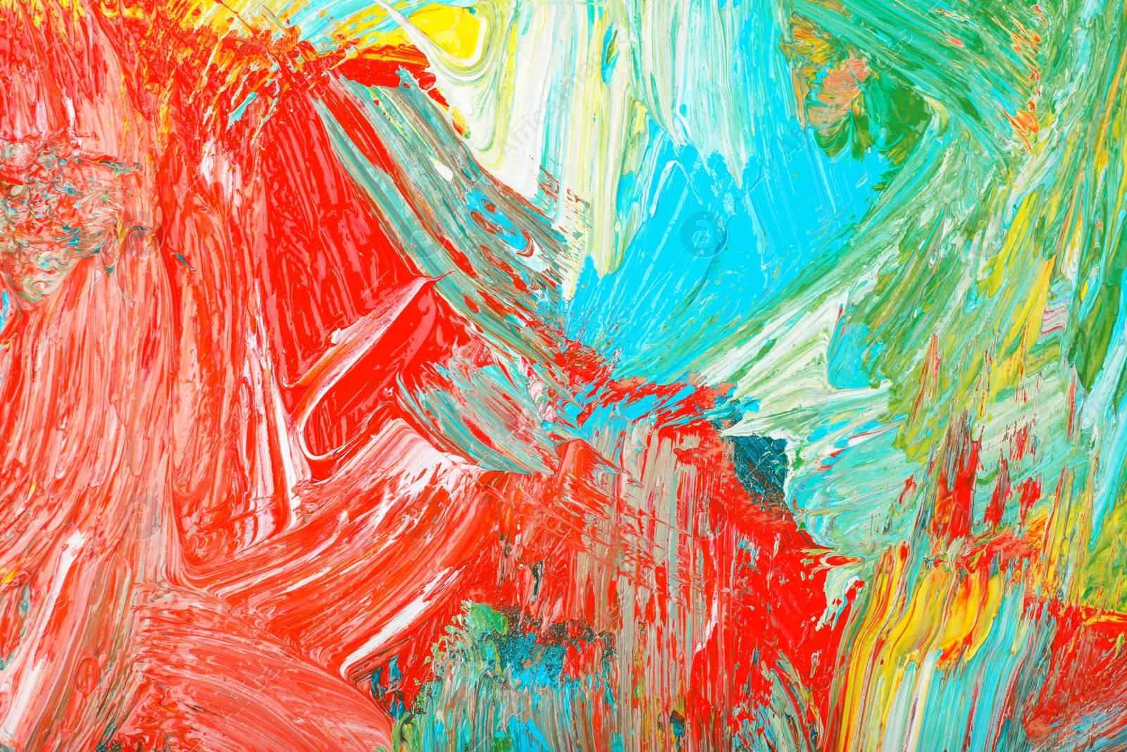 Photo of Closeup view of artist's palette with mixed bright paints as background