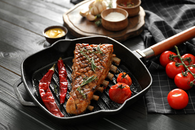 Photo of Delicious roasted ribs served on wooden table