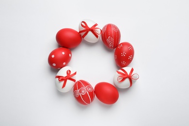 Frame made of red painted Easter eggs on white background, space for text