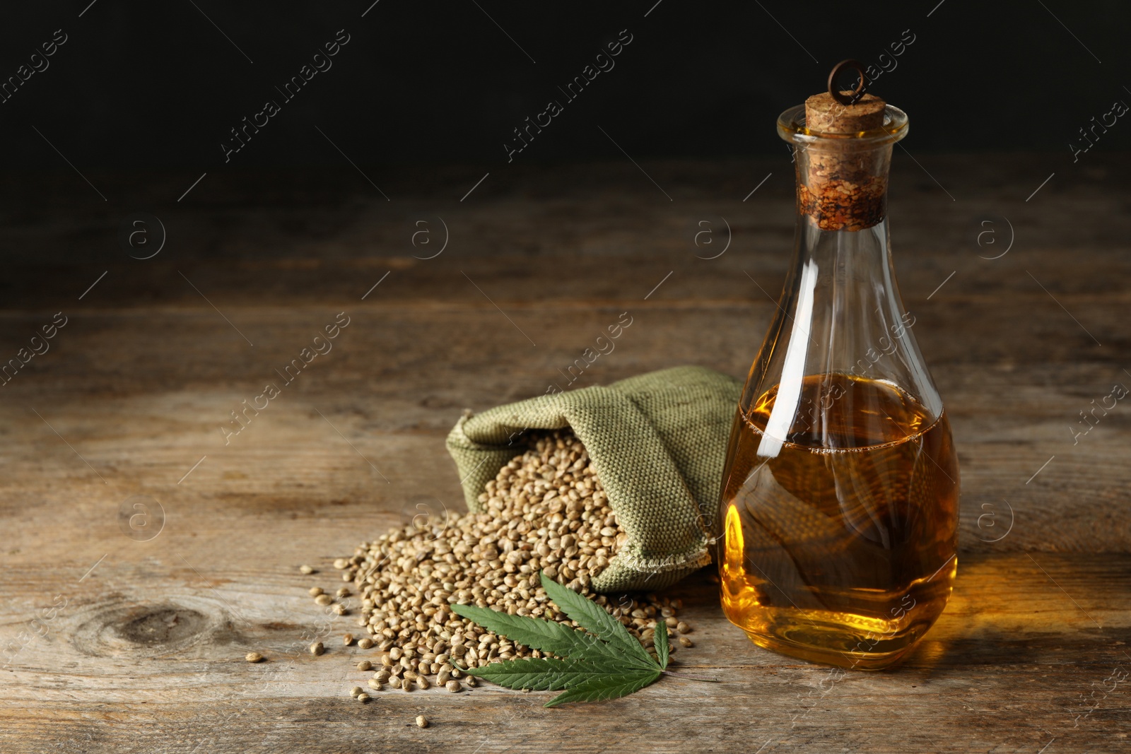 Photo of Composition with hemp oil on wooden table