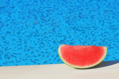 Photo of Slice of fresh juicy watermelon near swimming pool outdoors, space for text