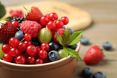 Photo of Mix of different fresh berries in bowl on table, closeup