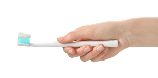 Photo of Woman holding toothbrush with paste on white background, closeup