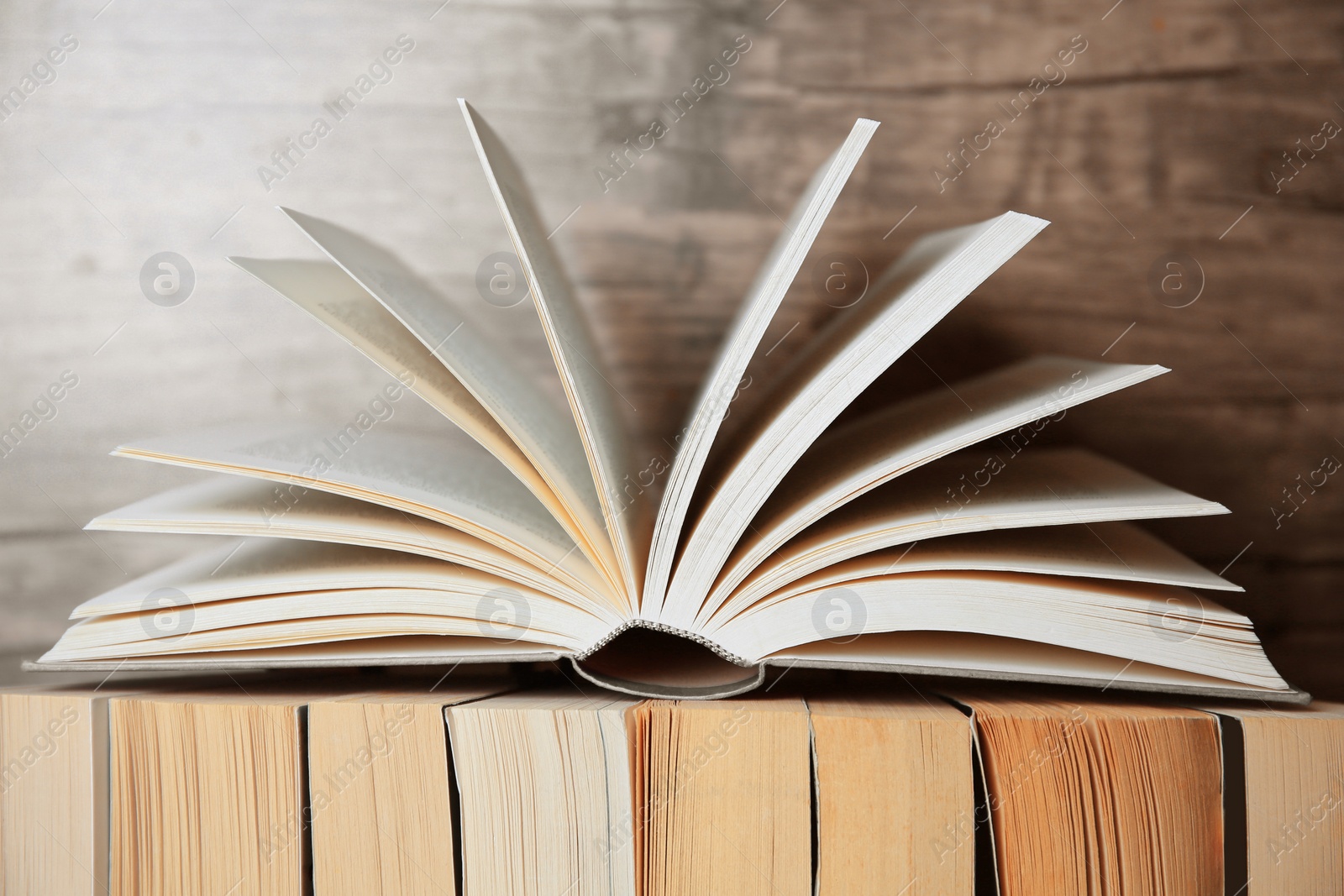 Photo of Different books against wooden background, closeup view